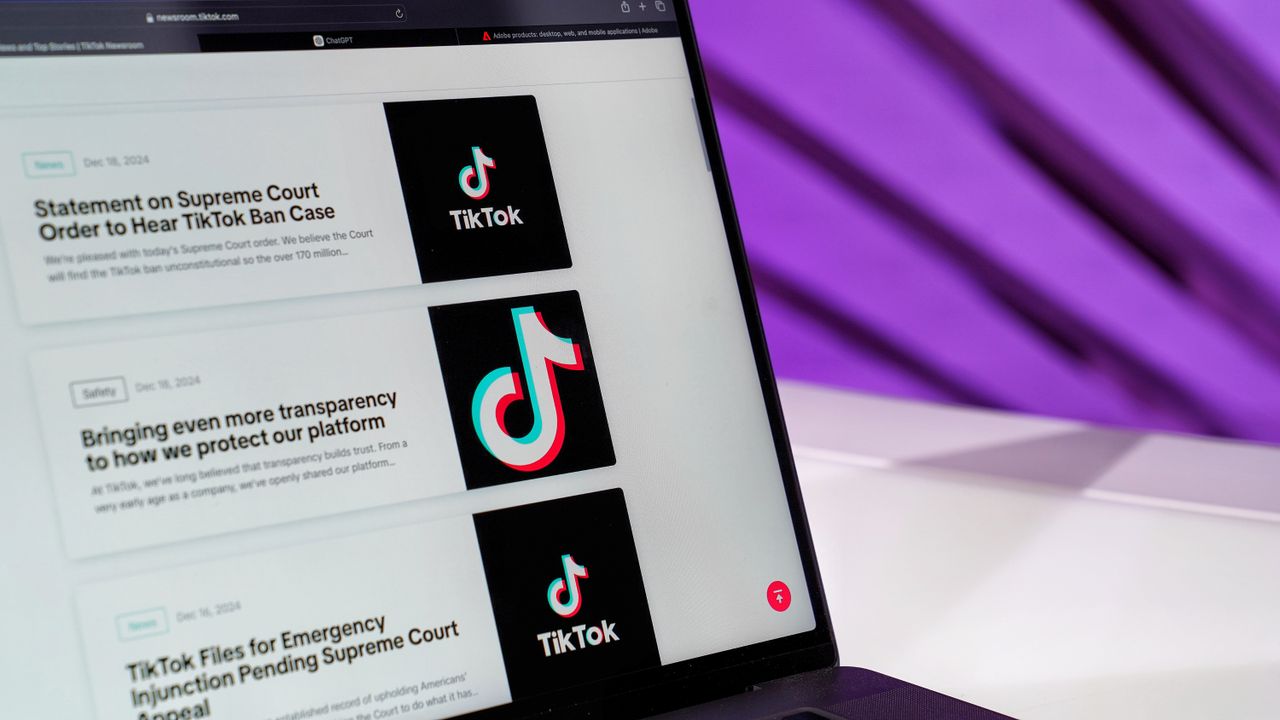 mobile-02 Close-up of laptop screen showing TikTok news articles with a purple background.